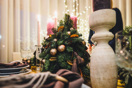 Christmas Eve table decorations, Christmas mood, Christmas tree on the dining table. Defocused