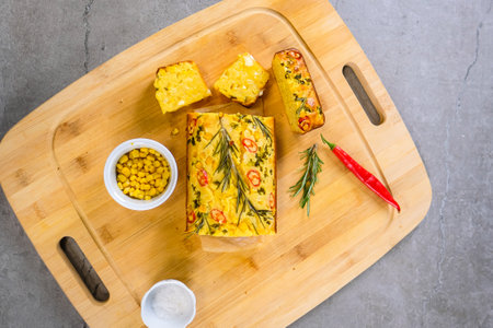 Freshly baked cornbread with red chili peppers. Defocusedの写真素材