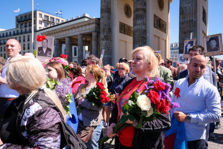 Berlin, Germany - May 9, 2023: Crowd of people with Russian and Soviet flags at Soviet War Memorial in Berlins Tiergartnen park on Soviet Victory Dayのeditorial素材