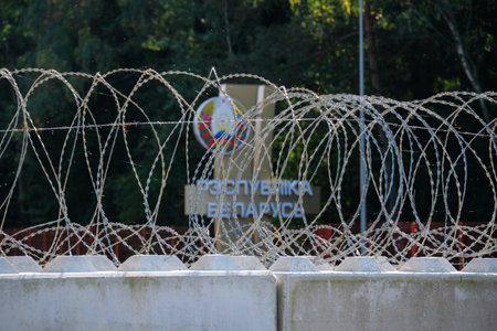 Silene, Latvia - September 26, 2023: Latvia - Belarus border, Belarus national emblem and coat of arms, barbed wireのeditorial素材