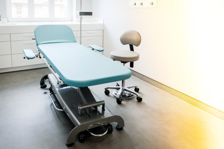 A doctors office with a couch and a chair to examine a patients healthの写真素材