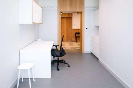 A doctors office with a couch and a chair to examine a patients health. Clean, bright hospital interiorの写真素材