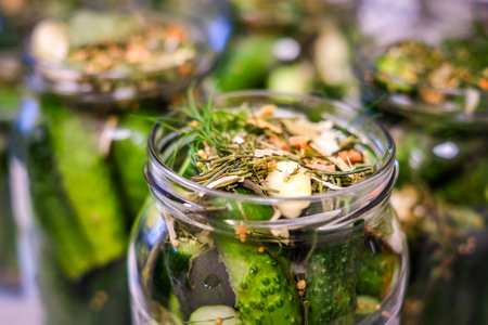 Homemade Pickled Cucumbers in Glass Jars with Spices and Herbs