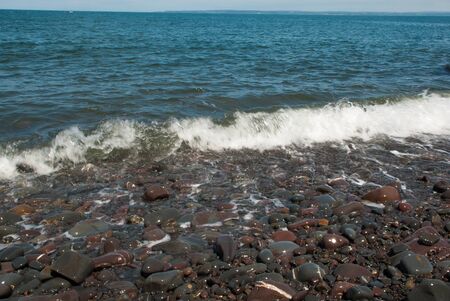 Wave washing over pebble beachの写真素材