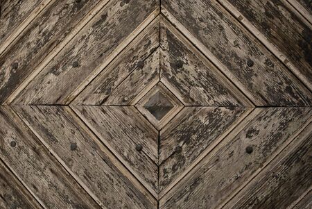 Detail of an old wooden patterned door as a background imageの写真素材