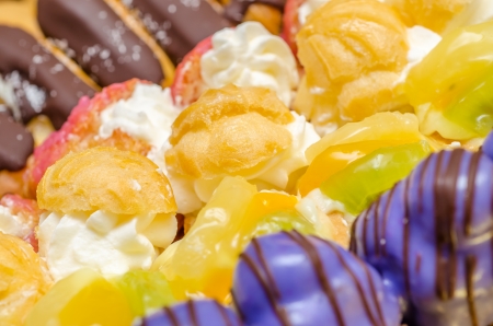 Multicolored Cookies With Whip Cream And Fruitsの写真素材