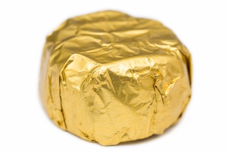 Candy In Golden Foil On A White Backgroundの写真素材