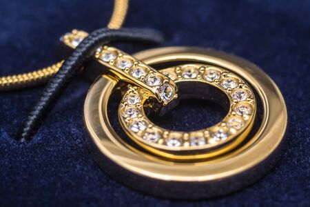 Macro Photo Of A Gold Necklace With Crystals In A Blue Soft Gift Boxの写真素材