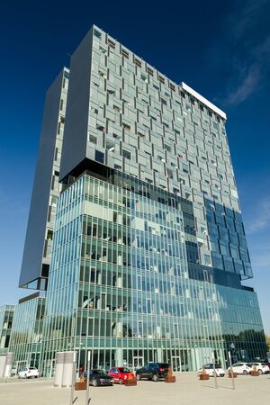Modern Office Building With Parking Lot On A Blue Sky In Bucharest, Romaniaのeditorial素材