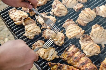 Closeup Of Man Preparing Pork Stakes On Barbecueの写真素材