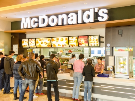 BUCHAREST, ROMANIA - APRIL 12: People buying fast-food from McDonald's Restaurant on April 12, 2013 in Bucharest, Romania. McDonald's is the main fast-food restaurant chain in Romania.のeditorial素材