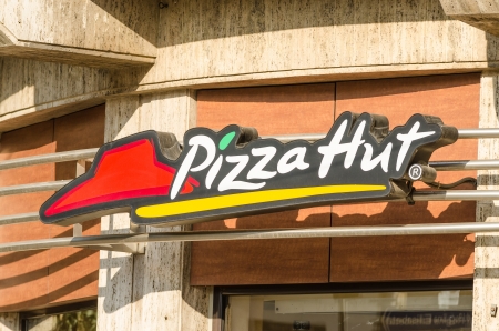 BUCHAREST, ROMANIA - JUNE 14: Pizza Hut Restaurant Sign on June 14, 2013 in Bucharest, Romania. It is an American restaurant chain and international franchise that offers different styles of pizza.のeditorial素材