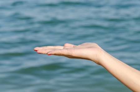 Empty Female Woman Hand Holding With Ocean Backgroundの写真素材