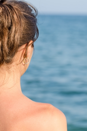 Beautiful Young Girl Looking At The Far Oceanの写真素材
