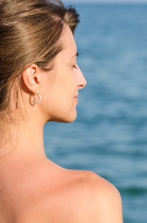 Beautiful Young Girl Enjoys The Ocean Breezeの写真素材