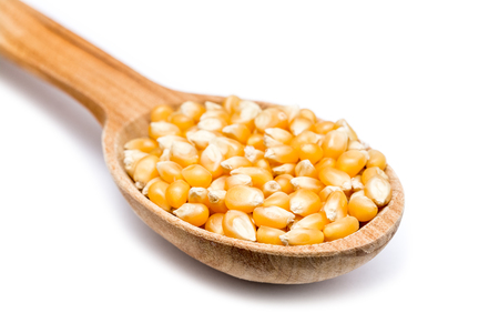 Wooden Spoon With Corn Seeds On Whiteの写真素材