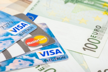 BUCHAREST, ROMANIA - DECEMBER 22, 2013  Visa And Mastercard Credit Cards Over European Union Official Euro Banknotesのeditorial素材