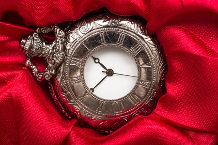 Vintage Pocket Mechanical Watch On Red Satin Backgroundの写真素材