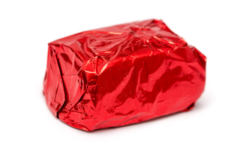 Red Wrapped Chocolate Candy Isolated On Whiteの写真素材