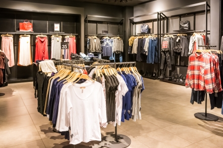 BUCHAREST, ROMANIA - JANUARY 22, 2014  Fashion Clothes On Racks In Beauty Clothes Store  Spring Clothes Collection Available For Sale In Fashion Clothes Store のeditorial素材