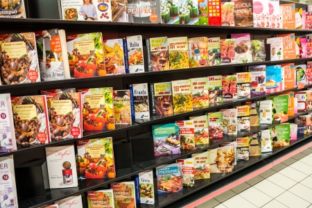 BUCHAREST, ROMANIA - JANUARY 22, 2014  Cooking Books On Shelf In Library Bookstore  A cookbook is a kitchen reference publication that typically contains a collection of recipes のeditorial素材