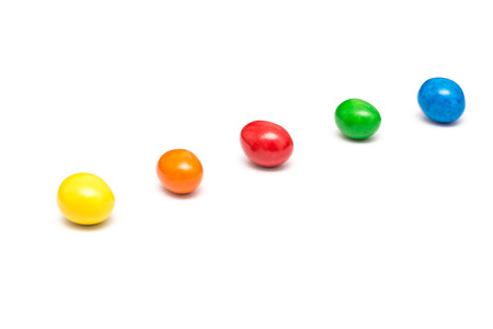 Colorful Row Of Coated Chocolate Candy Close Up Isolated On Whiteの写真素材
