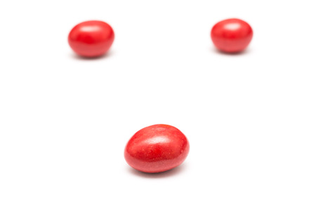 Red Coated Chocolate Candy Close Up Isolated On Whiteの写真素材