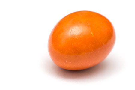 Orange Colored Coated Chocolate Candy Isolated On Whiteの写真素材