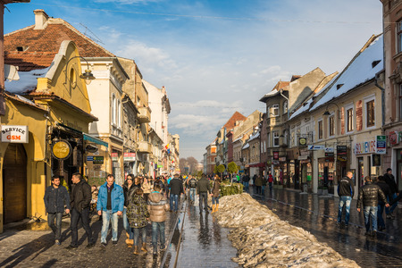 BRASOV, ROMANIA - FEBRUARY 09  Tourists Sightseeing Downtown on February 09, 2014 in Brasov, Romania  Brasov Is One Of The Main Touristic Cities Of Romania In The Carpathian Mountains のeditorial素材
