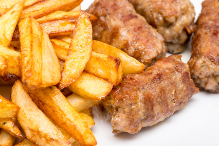 Traditional Romanian Dinner With Meatballs Or Mici And French Friesの写真素材