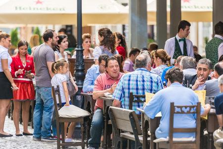 BUCHAREST, ROMANIA - JULY 04, 2014  Tourists Having Lunch At Outdoor Restaurant Downtown Lipscani Street  Lipscani is one of the most busiest streets of central Bucharest のeditorial素材