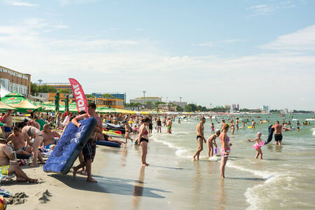 MAMAIA, ROMANIA - AUGUST 10, 2014: People Having Fun On Mamaia Beach At The Black Sea.のeditorial素材