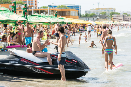 MAMAIA, ROMANIA - AUGUST 10, 2014: People Having Fun On Mamaia Beach At The Black Sea.のeditorial素材