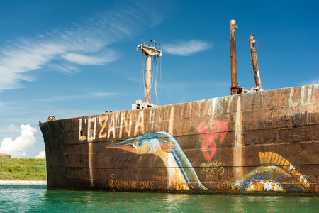 COSTINESTI, ROMANIA - JULY 31, 2014: The Old Shipwreck Near The Black Sea Beach. Opposite to the northern beach, the shipwreck of Evangelia, a Greek ship beached there in the late 1960s.のeditorial素材