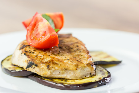 Grilled Eggplant Slice With Pork Chop And Sliced Tomatoes Close Upの写真素材