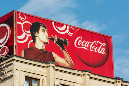 BUCHAREST, ROMANIA - AUGUST 06, 2014: Coca-Cola Advertising On Apartment Building. It  is a carbonated soft drink sold in stores and restaurants in every country except Cuba and North Korea.のeditorial素材