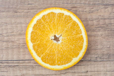 Orange Slice On Wood Tableの写真素材