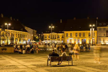 SIBIU, ROMANIA - AUGUST 19, 2014: Night Life In The Upper Town Part Of Sibiu Historical Center. The Upper Town contains most points of interest in the city and is organised around three city squares.のeditorial素材