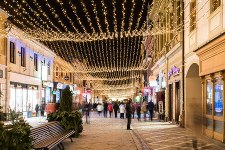 BRASOV, ROMANIA - DECEMBER 22, 2014:  Downtown Brasov City At Night With Christmas Decorations. Brasov Is One Of The Main Touristic Cities Of Romania In The Carpathian Mountains.のeditorial素材