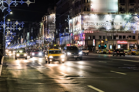 BUCHAREST, ROMANIA - DECEMBER 22, 2014:  High Traffic On Christmas Eve Downtown Of Bucharest City At Night In The University Square.のeditorial素材
