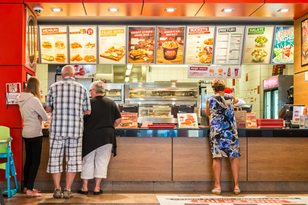 TIMISOARA, ROMANIA - AUGUST 25, 2014: People Order Kentucky Fried Chicken In Fast-Food Restaurant....
