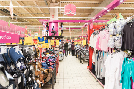 BUCHAREST, ROMANIA - FEBRUARY 15, 2015: People Shopping For Cheap Clothes In Supermarket Store Aisle.のeditorial素材