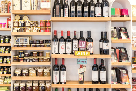 BUCHAREST, ROMANIA - MARCH 05, 2015: Red Wine Bottles, Jam Jars And Chocolate On Supermarket Stand.