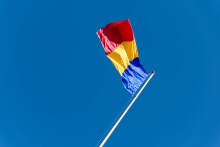 Flag Of Romania On Blue Skyの写真素材