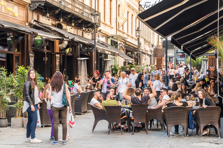 BUCHAREST ROMANIA  MAY 18 2015: Tourists Visiting And Having Lunch At Outdoor Restaurant Cafe Downtown Lipscani Street one of the most busiest streets of central Bucharest.のeditorial素材