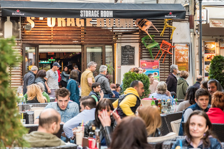 BUCHAREST ROMANIA  MAY 31 2015: Tourists Visiting And Having Lunch At Outdoor Restaurant Cafe Downtown Lipscani Street one of the most busiest streets of central Bucharest.のeditorial素材