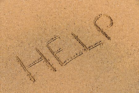 Help Sign Drawn On Beach Sandの写真素材