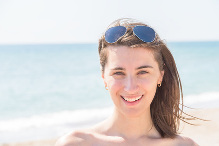 Portrait Of Pretty Young Woman Is Happy On Summer Ocean Beachの写真素材