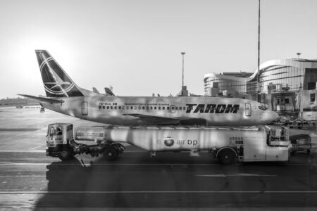 BUCHAREST, ROMANIA - AUGUST 03, 2015: Tarom Airplane Landing On Bucharest Henri Coanda Otopeni International Airport.のeditorial素材
