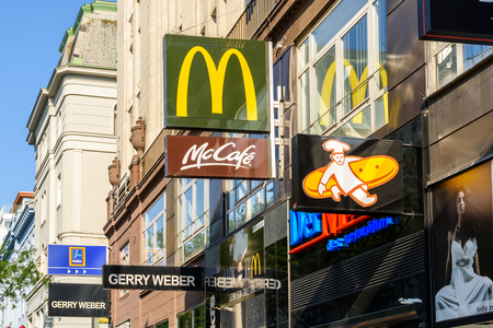 VIENNA, AUSTRIA - AUGUST 08, 2015: Restaurants And Cafe Famous Brands Advertising On Mariahilferstrasse Street, One Of The Most Busiest Streets In Downtown Vienna City.のeditorial素材